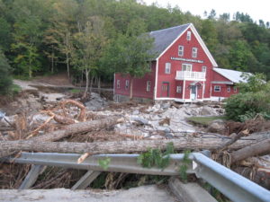 A road in front of a historic mill building was washed away in floodwaters following Tropical Storm Irene