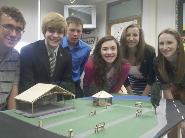 Chelsea Gump (far right) and other members of Brownville High School’s Students in Action team stand with a model of the park and performance stage planned for downtown Brownsville. (Photo courtesy of the Herald-Standard)