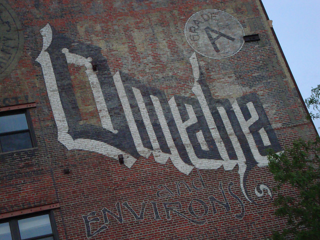 A handpainted sign on the side of one of the many of the re purposed historic buildings in Omaha's Old Market