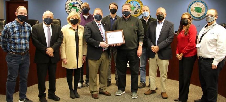 The Western Piedmont Council of Governments (NC) received a 2021 NADO Impact Award for the Unifour HOME Consortium. Here, staff are pictured with the City of Lenoir City Council who were recognized for their support of this program that has has provided financial assistance to 3,005 first-time homebuyers, funded 14 non-profit organizations, and made loans to 20 low-income multi-family housing tax-credit projects.